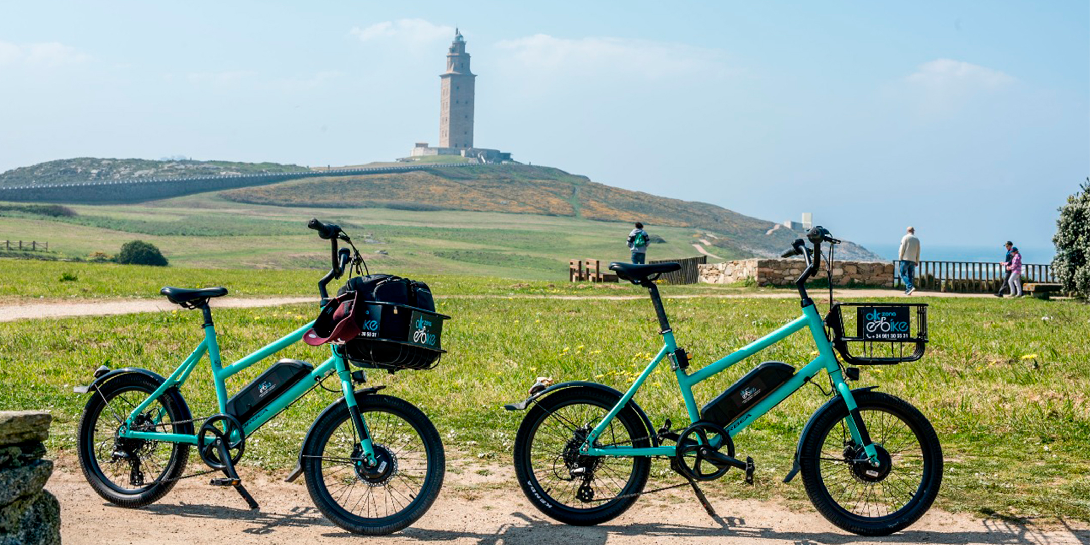 eBikes parked near A Coruña coastline sunny day